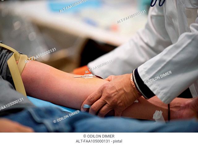 Person giving blood, close-up