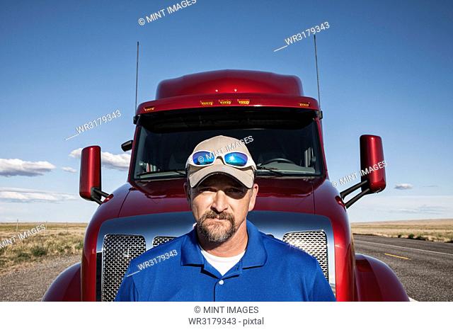 Portrait of a Caucasian man driver and his commercial truck