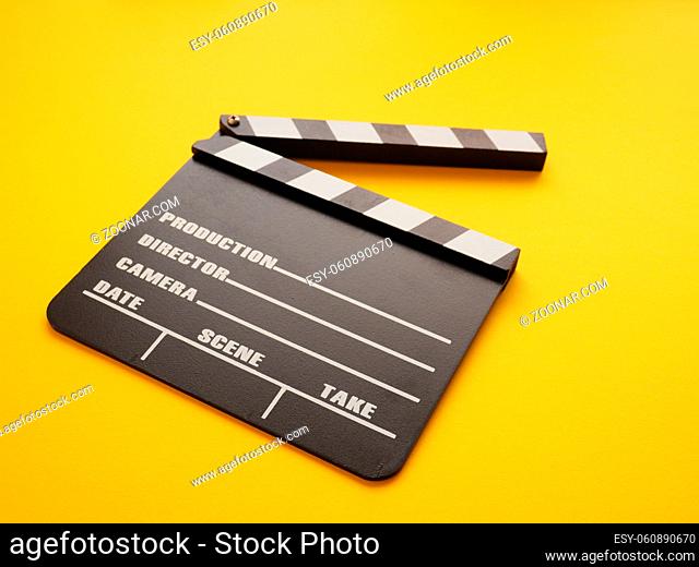 Clapboard on a yellow background, cinema or movie concept