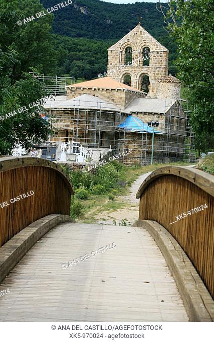 Wooden bridge and Romanesque church of San Salvador de Cantamuda (12th century). Palencia province, Castilla-León, Spain