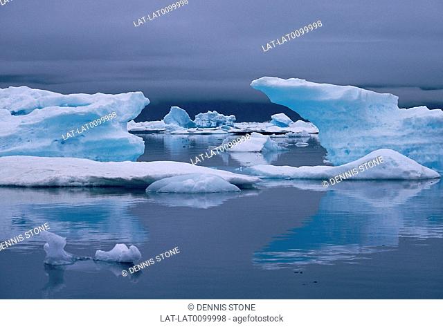 Mountains. Snow. Ice floes, large turqouise colored blocks in water