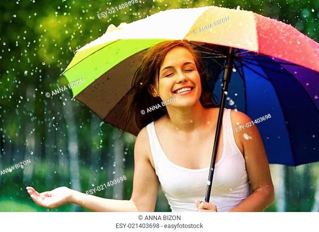 Beautiful woman enjoying summer rain