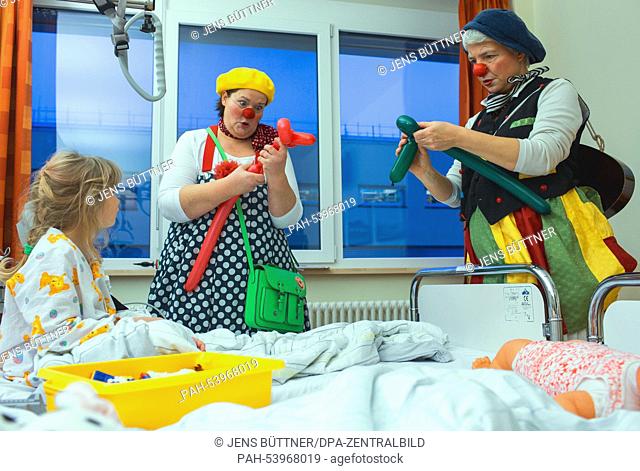 Ines Vowinkel (R) as ""Fine"" and Kerstin Daum as ""Kiki"" (C) visit seven year-old Vivian at the children's station at the Helios Clinic in Schwerin, Germany