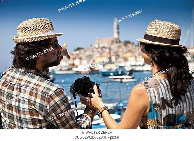 Couple looking at digital photos