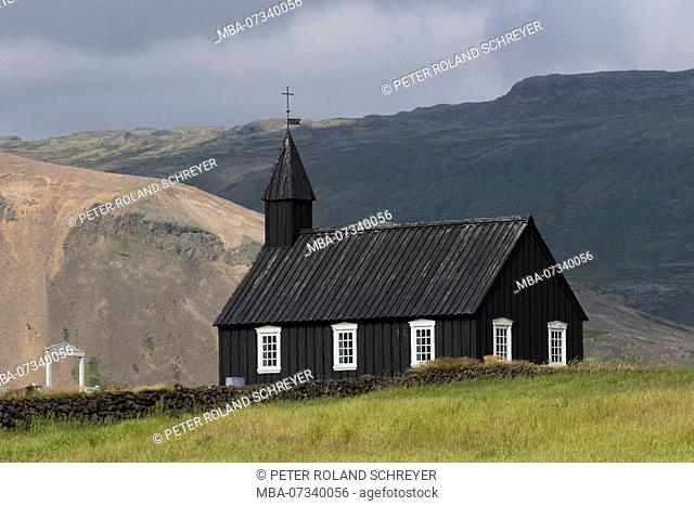 Iceland, Black Church at Budir, mountains in the background, Snaefellsnes peninsula