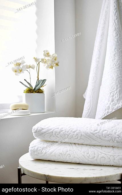 A stack of clean white towels in a spa setting