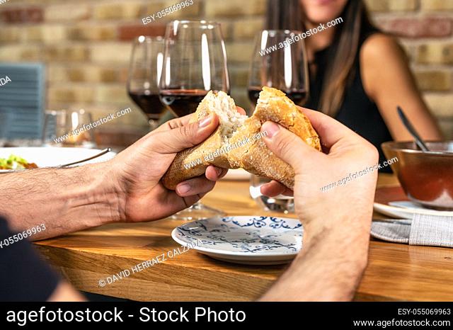 Unrecognizable Group of friends eating together and drinking wine in a restaurant. High quality photo