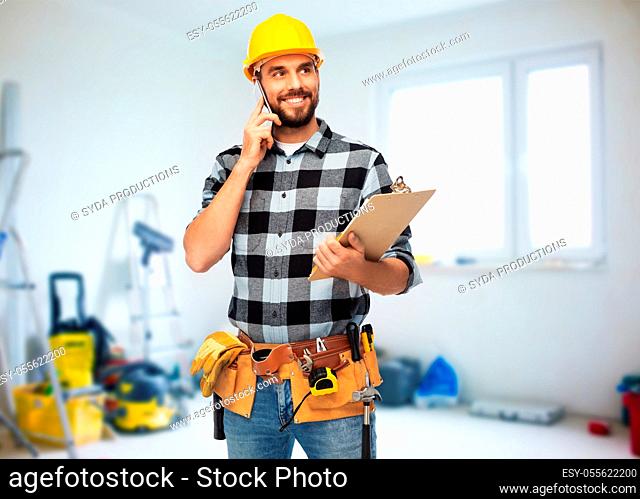 happy builder with clipboard calling on smartphone