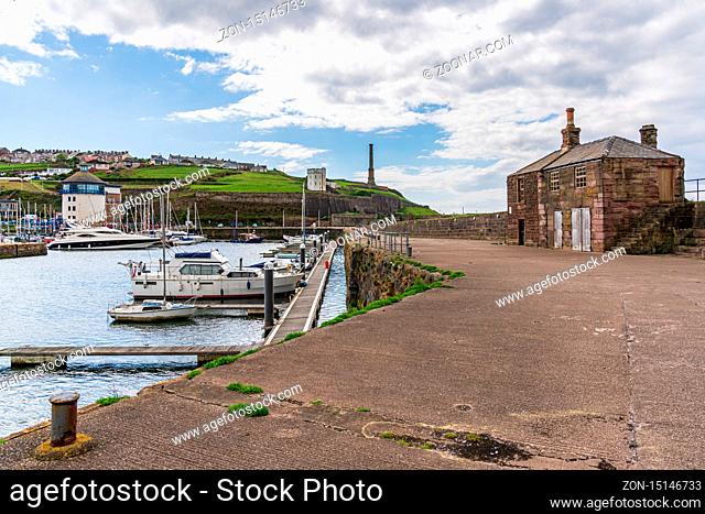 Whitehaven, Cumbria, England, UK - May 03, 2019: View from the end of the Old Quay towards the Harbour and the Candlestick Chimney