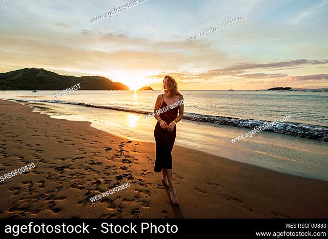 Woman enjoying sunset at Del Coco beach, Guanacaste Province, Costa Rica