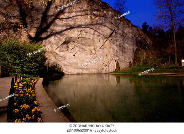 dying lion monument in Lucern Switzerland twilight with flower