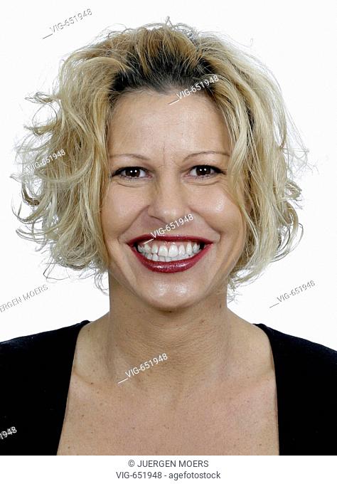 Portrait of a young pretty woman who looks joyfully. - DORSTEN, NORTH RHINE-WESTPHALIA, GERMANY, 25/02/2008