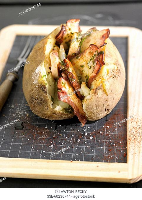 Baked potato stuffed with octopus and pesto olive oil