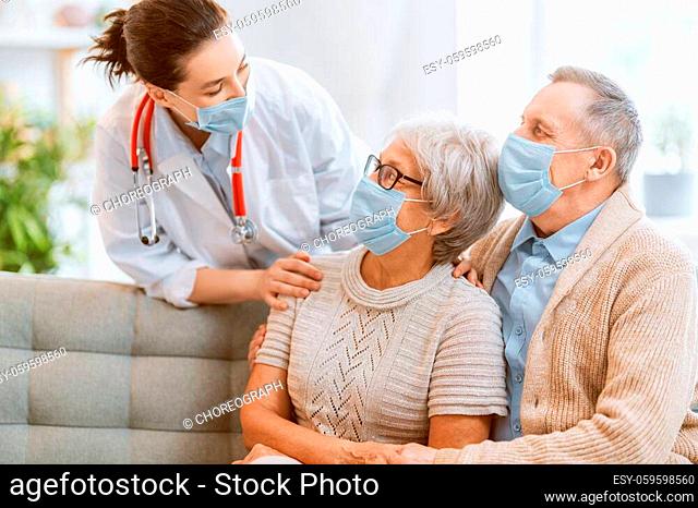 Doctor and senior couple wearing facemasks during coronavirus and flu outbreak. Virus protection, home quarantine. COVID-2019. Taking on masks