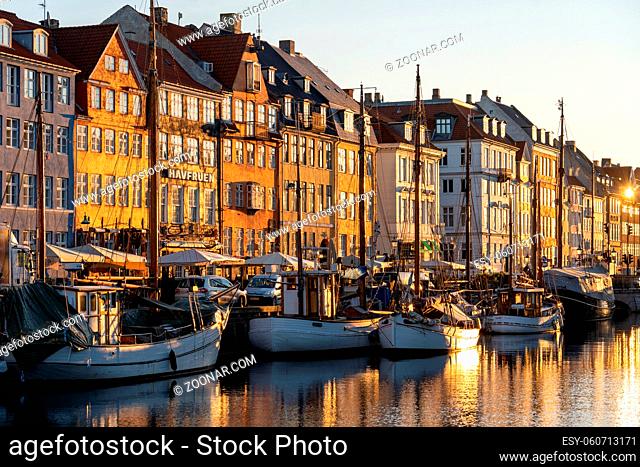 Copenhagen, Denmark - February 02, 2020: Colorful houses and boats in famous Nyhavn during sunrise