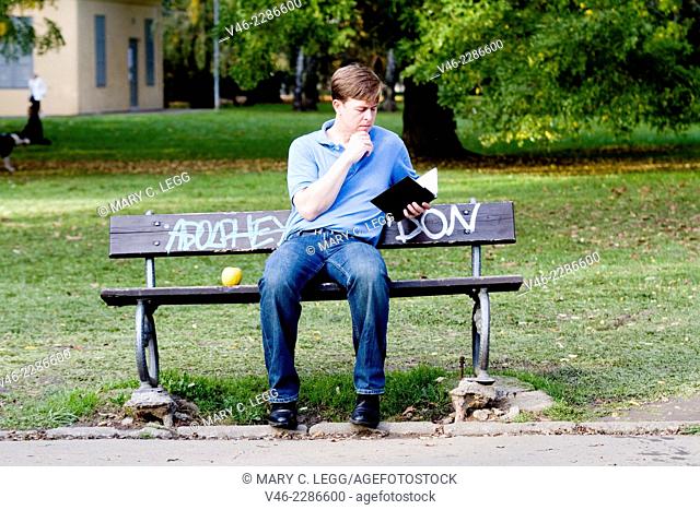 Young man sitting on a park bench