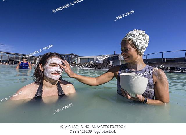 Guests enjoy the thermal waters and mud treatments of the Blue Lagoon, BlaÌ. a loÌ. nið , Iceland