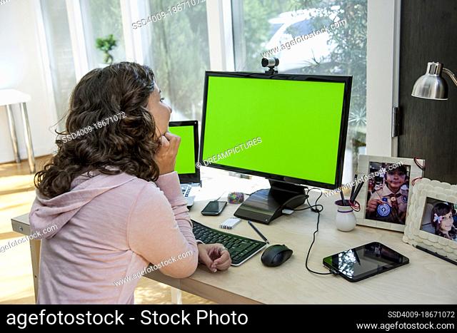 Young Hispanic woman on a video call in home office