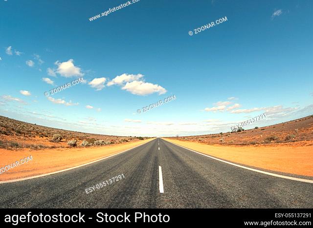 An image of a road in Australia with curved horizon