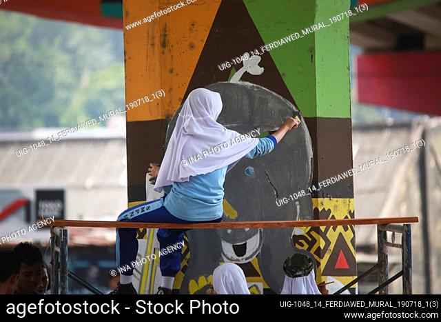 Students seen painting murals at Bandar Lampung flyover, on Thursday, July 18, 2019. 1, 500 junior high school students paint murals on 560 poles in welcoming...