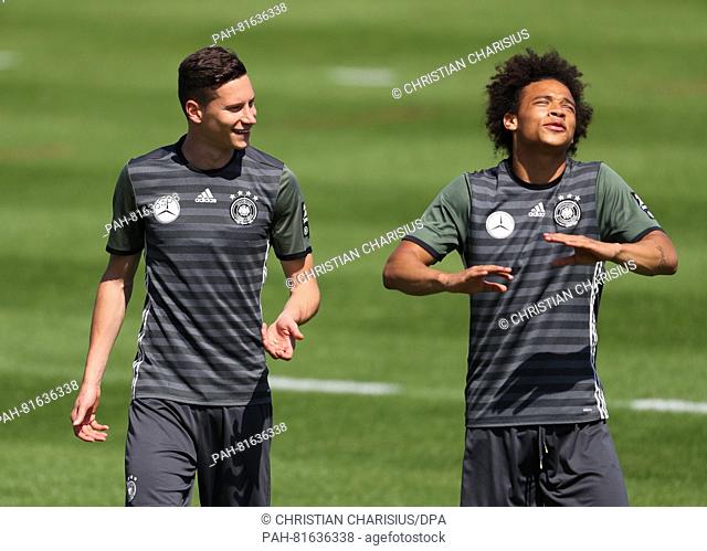 Germany's Julian Draxler (L) and Leroy Sane during a training session of the German national soccer team on the training pitch next to team hotel in Evian