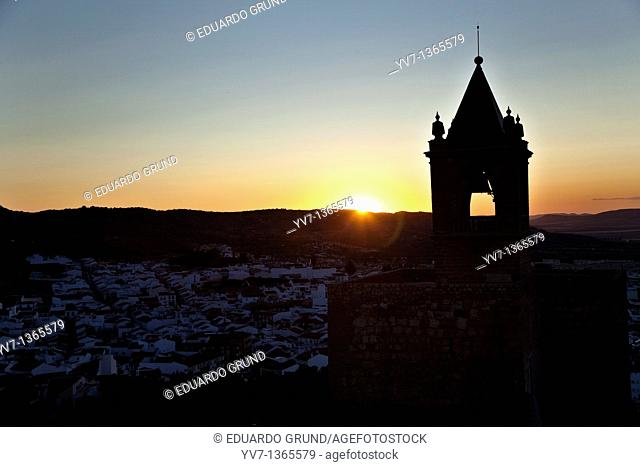 The sunset, with the Tower of Homage of the Alcazaba to the light, made from the White Tower of the Citadel of Antequera, Antequera, Andalusia, Spain