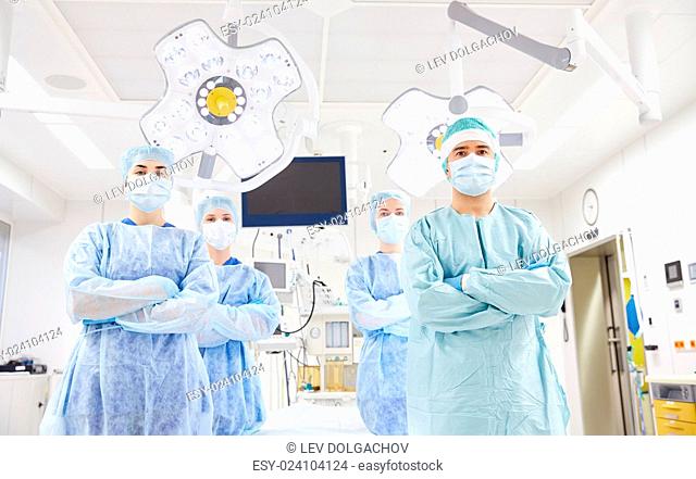 surgery, medicine and people concept - group of surgeons in operating room at hospital