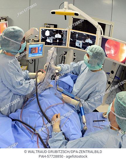 Attending Dirk Lindner (l-r) and Dr. Khaled Gaber perform a surgery on a patient with a brain tumor in an operating room of Leipzig University Hospital's...