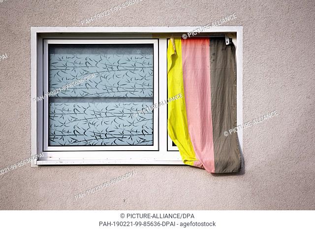 14 February 2019, North Rhine-Westphalia, Herford: A German flag hangs in the window of a house. Photo: Friso Gentsch/dpa