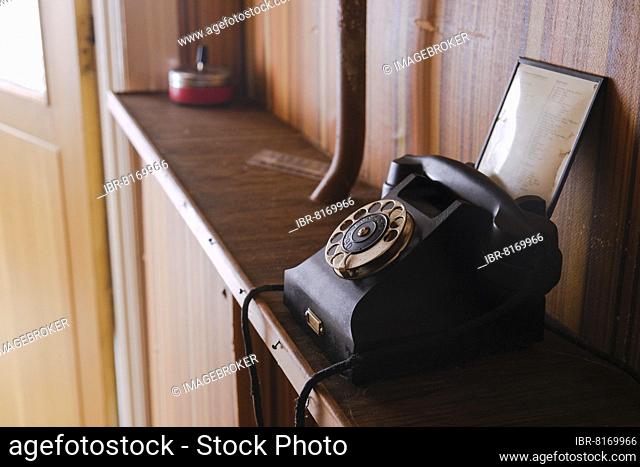 Old telephone with dial, red ashtray at the back, Malung, Dalarna, Sweden, Europe