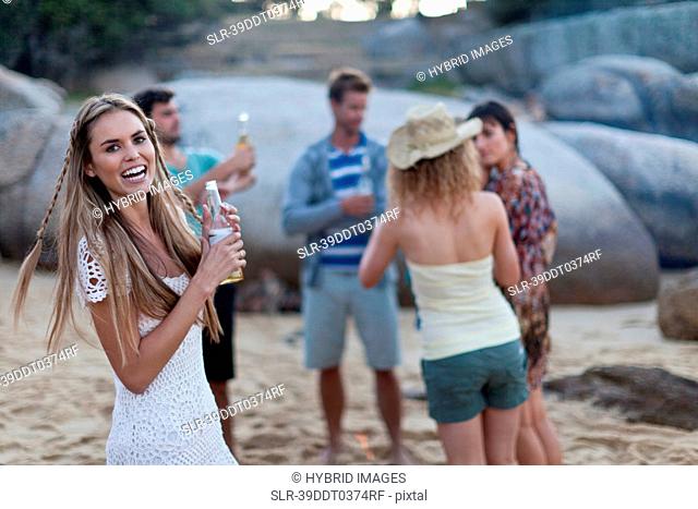 Friends drinking and relaxing on beach