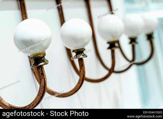 old row vintage coat rack with a porcelain ball
