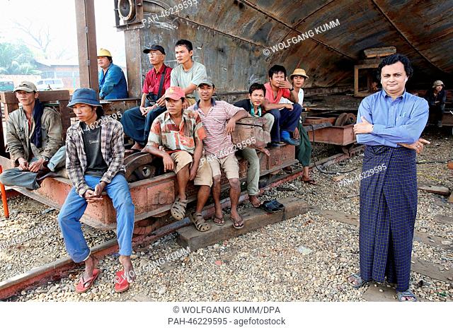 Dock workers sit in front of a vessel under construction during a baptism ceremony of a converted passanger boat, called the 'Swimming Doctors 2' (not in...