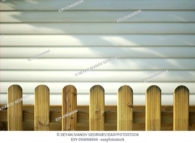 Wooden decorative fence and white wall