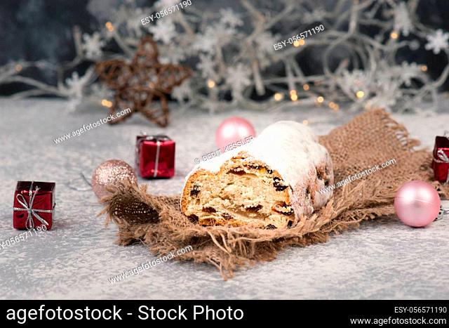 Christstollen, traditonal christmas cake with nuts, raisons, marzipan on a blue background, empty space for text