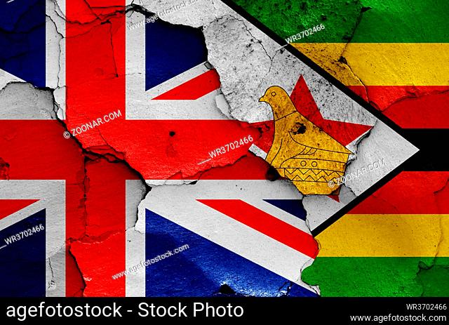 flags of UK and Zimbabwe painted on cracked wall