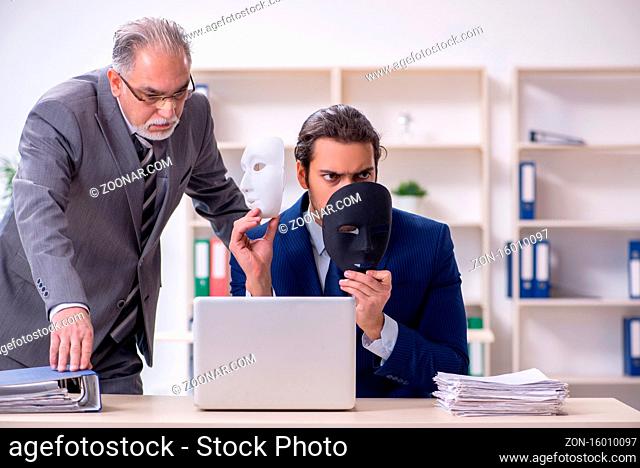 The old boss and young male employee wearing masks