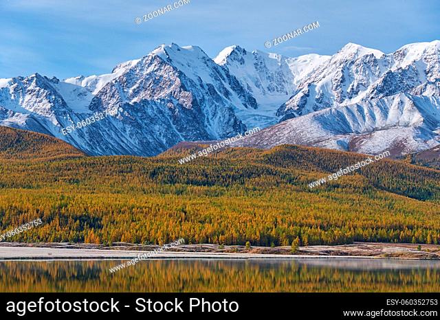 View on Altai lake Dzhangyskol on mountain plateau Eshtykel. Summit Aktru and glacier of North Chui ridge is reflecting in the water
