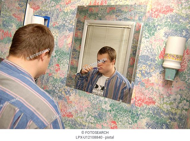 Man with a disability brushing his teeth and preparing for his day