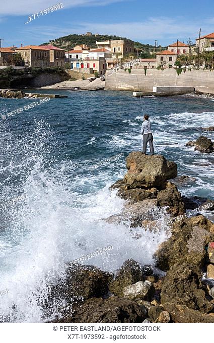 Man fishing off the rocks in the fishing village of Trahila, in the Outer Mani, Southern Peloponnese, Greece