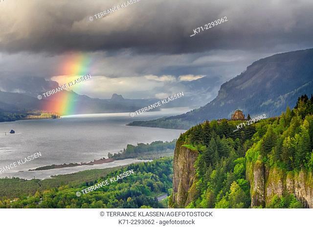 A view down the Columbia River gorge with a rainbow near sunset, Oregon, USA