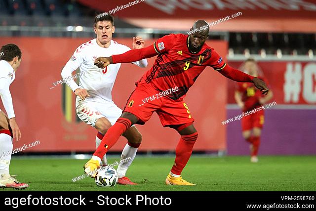 Danish Joakim Maehle and Belgium's Romelu Lukaku fight for the ball during a soccer game between the Belgian national team Red Devils and Denmark