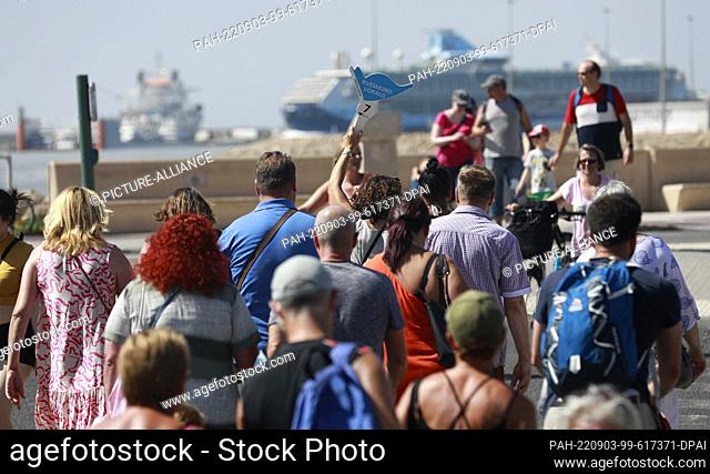 03 September 2022, Spain, Palma: A group of tourists follows a guide to the cruise ship AidaCosma in the port of Palma. Photo: Clara Margais/dpa