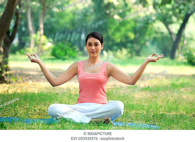 Young fresh woman in a yoga pose