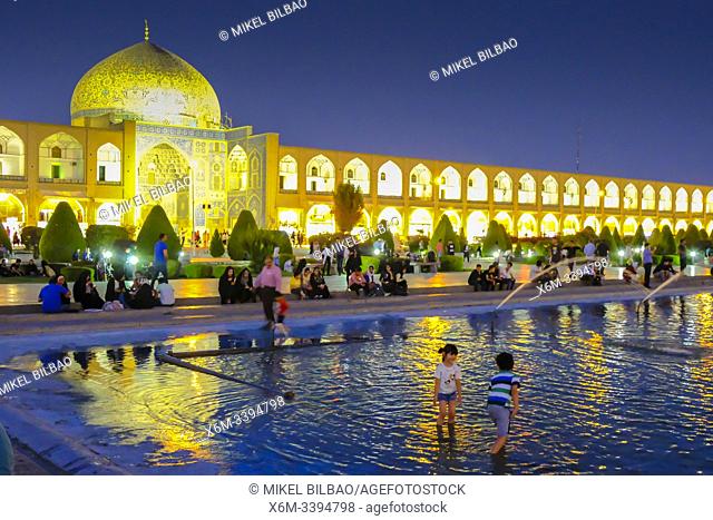 Naqsh-e Jahan Square, fountain and Sheikh Lotf Allah Mosque at dusk. Isfahan, Iran. Asia