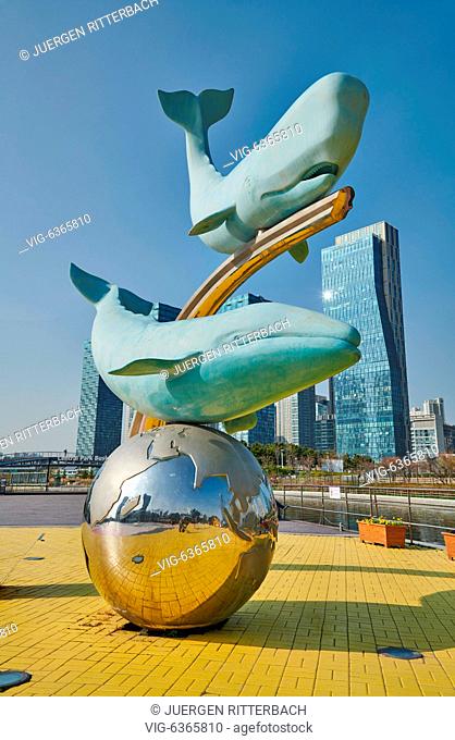 SOUTH KOREA, INCHEON CITY, 19.04.2019, whale figures in Central Park of Songdo International Business District with skyscraper in the back, Incheon City