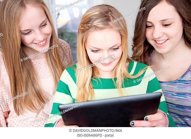 Girls looking at digital tablet