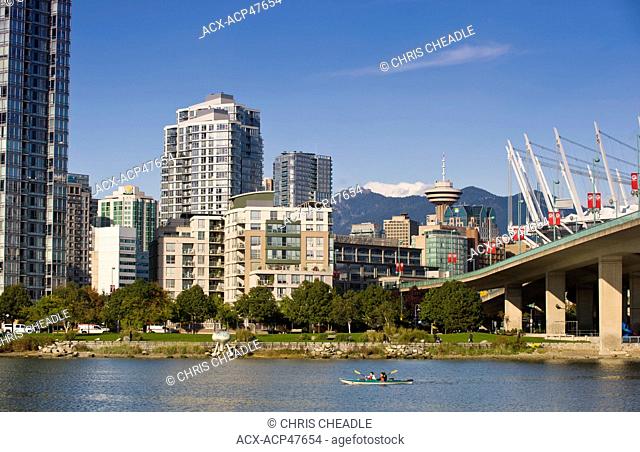 Kayakers and Cambie Bridge, city skyline with new retractable roof on BC Place Stadium, False Creek, Vancouver, British Columbia, Canada