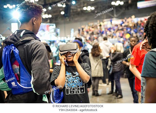 Participants use a Samsung Gear VR virtual reality device a the Two Sigma Investments booth at a Career Expo held at the FIRST Robotics NYC Championship at the...
