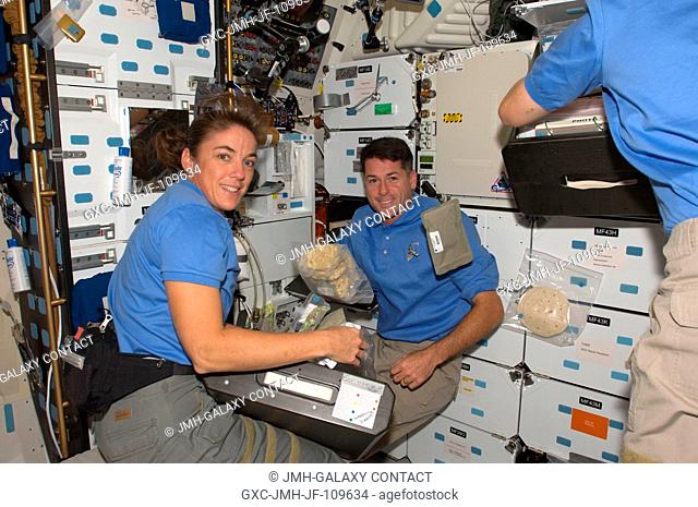 Stationed near the shuttle's galley and stowage lockers, astronauts Heidemarie Stefanyshyn-Piper and Shane Kimbrough, STS-126 mission specialists